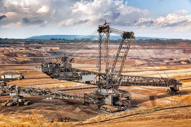 Ein gewaltiger Schaufelradbagger, der in einem Tagebau im Einsatz ist.